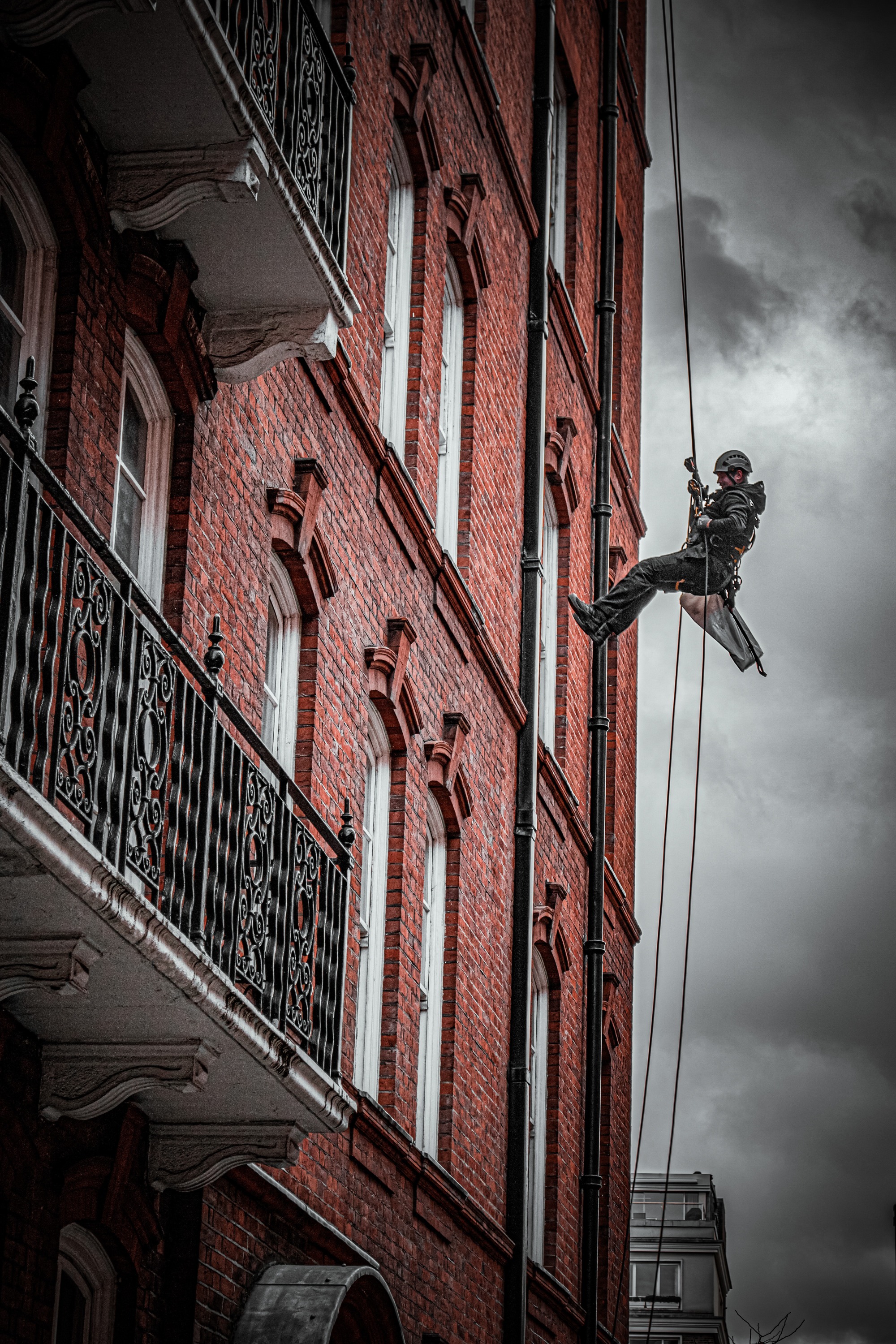 Abseiler descending from a building