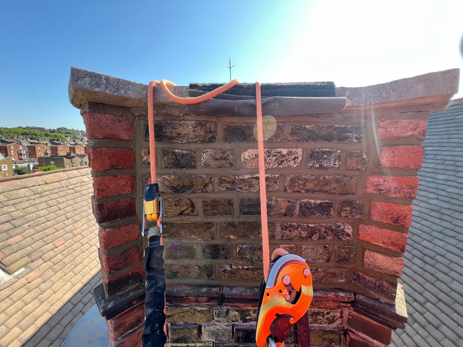 Rope access rigging on a chimney stack, anchor and rope at the head of the stack
