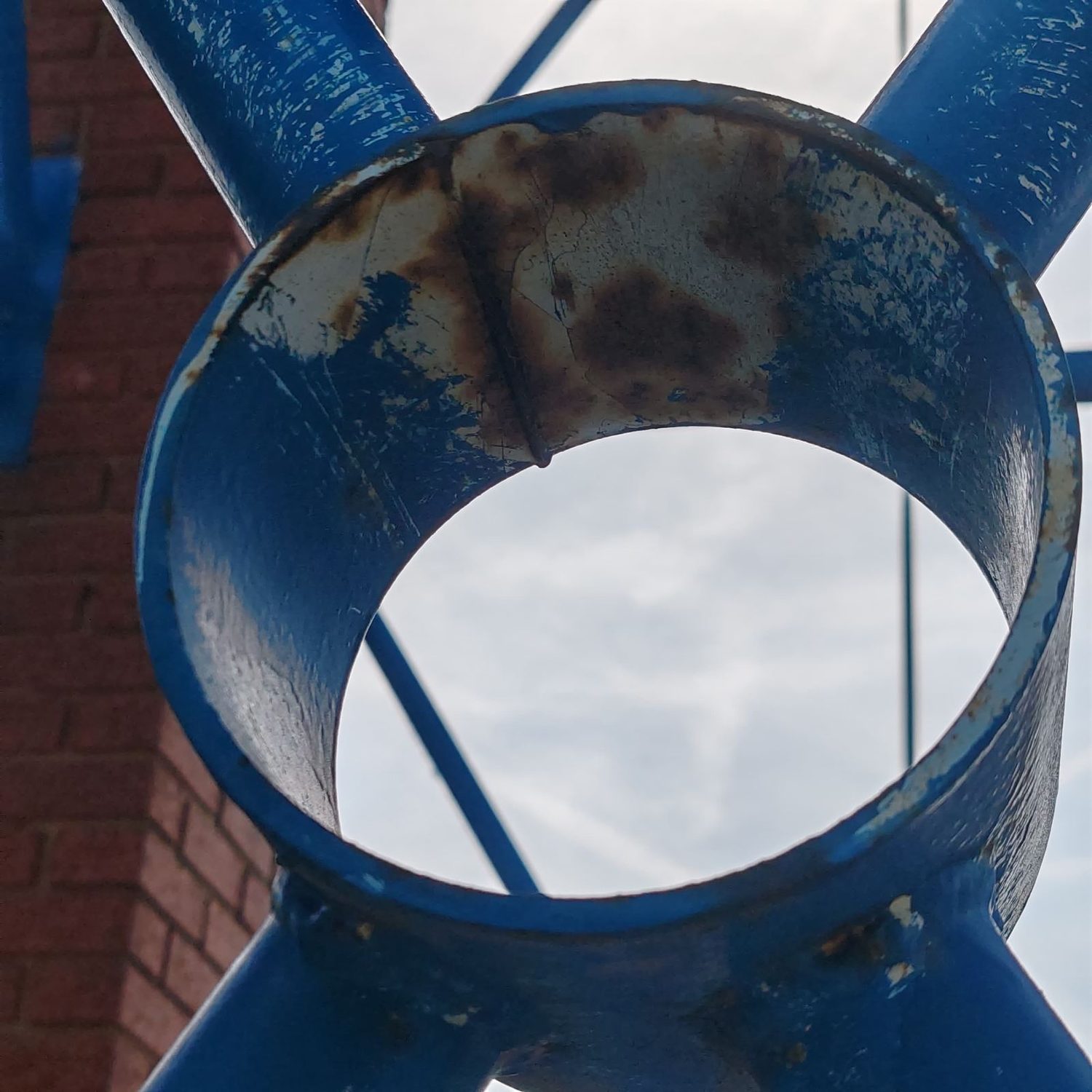 Decorative blue steel hub node with corrosion visible inside the inner bore